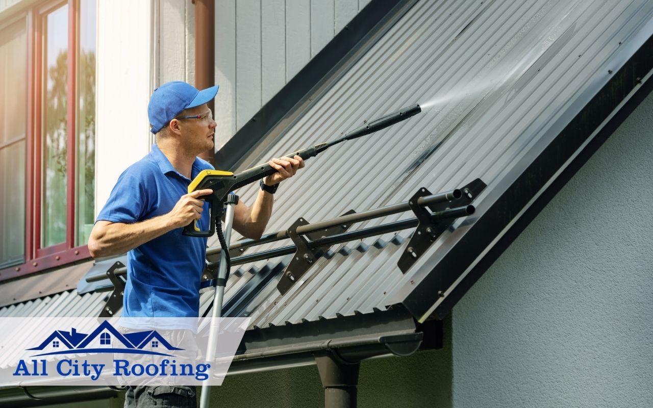 Technician cleaning a metal roof in Kennewick, WA