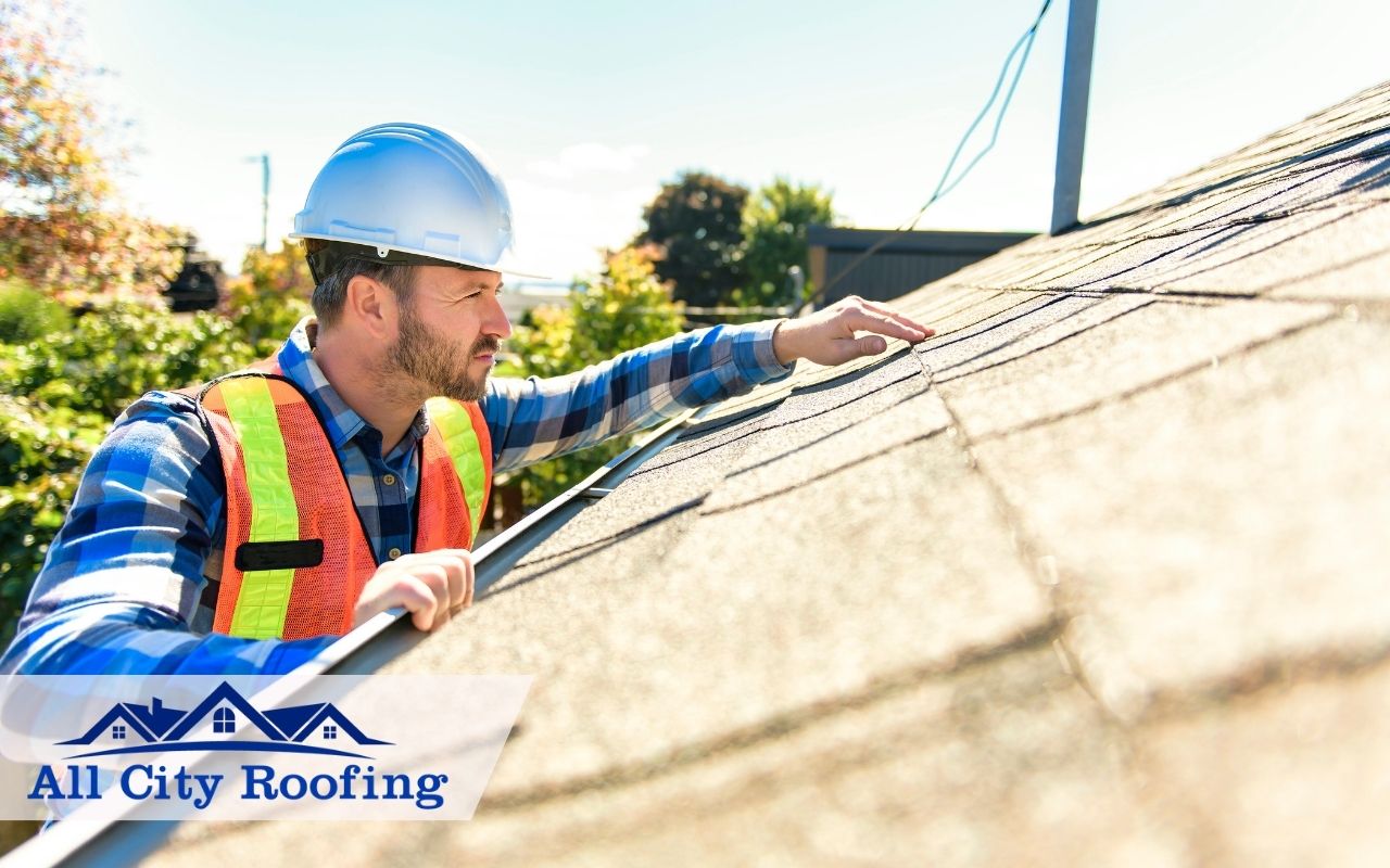 Roofer inspecting a residential roof in Kennewick during summer